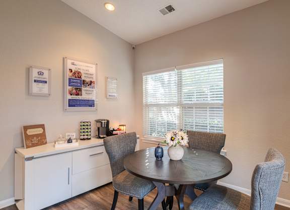 A dining room with a table set for two and a window with blinds.at The Village at England Run, Fredericksburg, VA 22406  