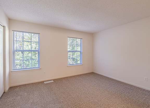 A room with two windows and carpeted floor.at The Village at England Run, 22406  