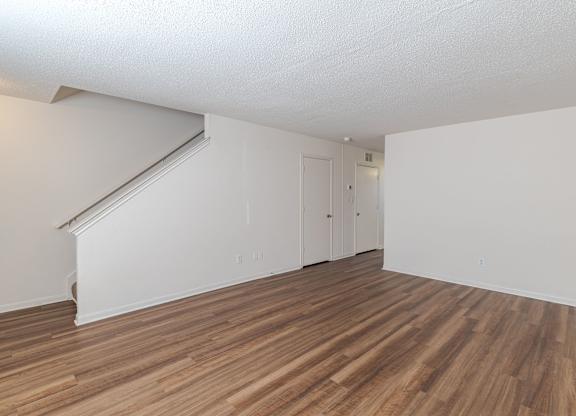 A room with wooden flooring and white walls.at The Village at England Run, Virginia  