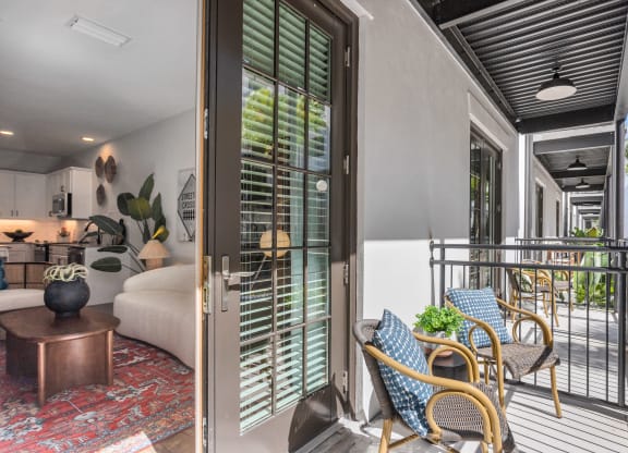 a living room with a bed and a balcony at Casa Marti, Tampa, FL
