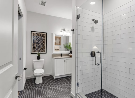 a white bathroom with a shower and a toilet at Casa Marti, Tampa, FL