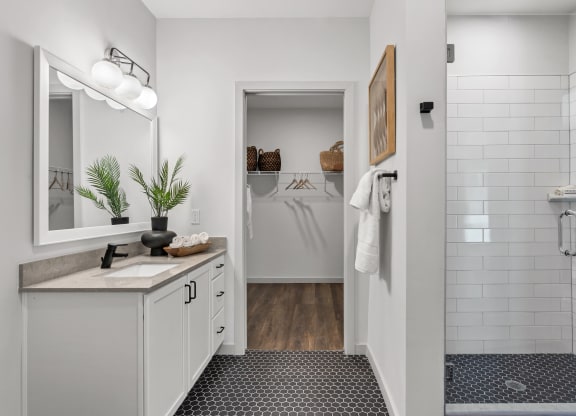 a white bathroom with a shower and a sink and a mirror at Casa Marti, Tampa