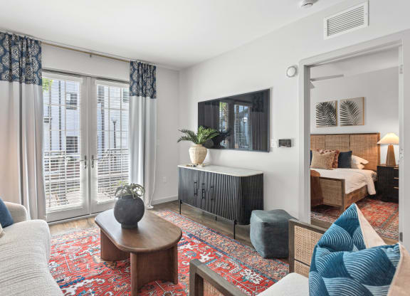 a living room with a couch and a tv and a door to a bedroom at Casa Marti, Tampa, FL, 33605