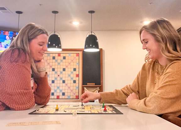 Two women playing a board game together.