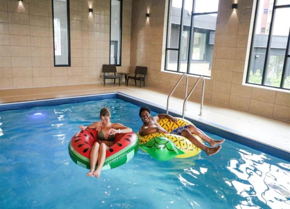 two people in a swimming pool with inner tubesat Bluestone Lofts, Duluth, MN 55803