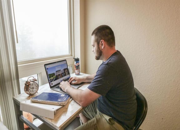 a man sitting at a desk using a laptop computerat Bluestone Lofts, Duluth Minnesota