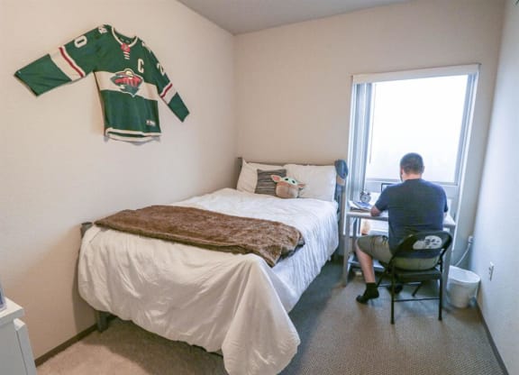 a man sitting at a desk in a room with a bedat Bluestone Lofts, Duluth Minnesota