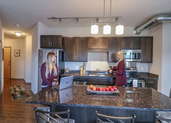 two women standing in a kitchen with a counter top at Bluestone Lofts, Duluth, MN
