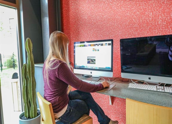 a woman sitting at a desk working on a computer at Bluestone Lofts, Duluth, 55803