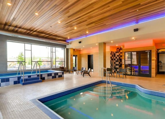 a swimming pool in the middle of a building with a wood ceiling at Bluestone Lofts, Minnesota