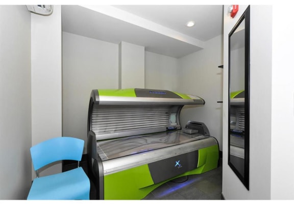 an empty room with a printer and two blue chairs at Bluestone Lofts, Minnesota, 55803