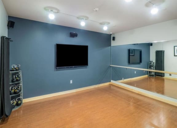 a large room with a tv on the wall and a wooden floor at Bluestone Lofts, Duluth, MN 55803