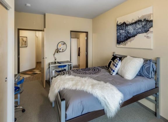 a bedroom with a bed and a desk at Bluestone Lofts, Duluth, 55803