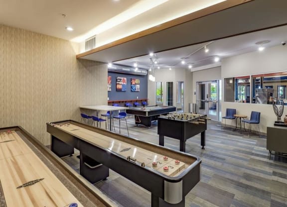 a games room with two shuffleboards and tables at Bluestone Lofts, Minnesota