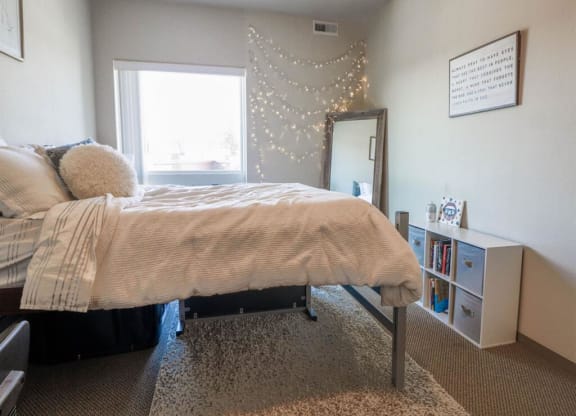 a bedroom with a bed and a dresser and a window at Bluestone Lofts, Duluth Minnesota