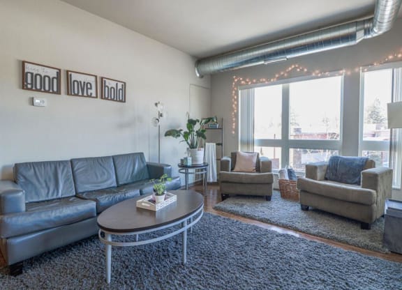 a living room with couches and chairs and a coffee table at Bluestone Lofts, Duluth, MN