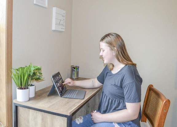 a woman sitting at a desk with a laptop computer at Boulder Ridge, Minnesota, 55811