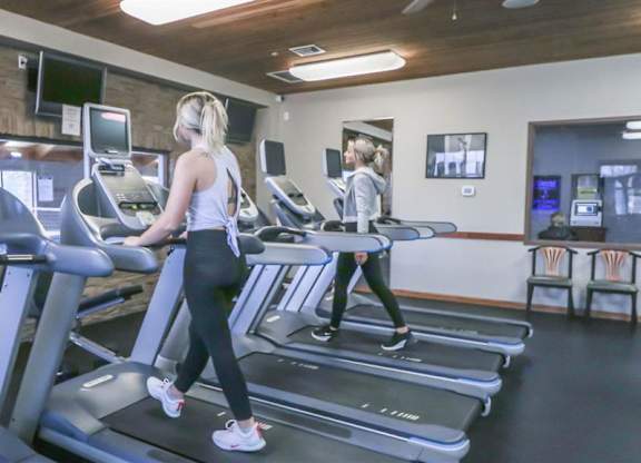 a woman walking on a treadmill in a gym at Boulder Ridge, Duluth Minnesota