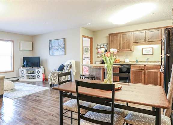 a living room and kitchen with a wooden table at Boulder Ridge, Duluth, MN 55811