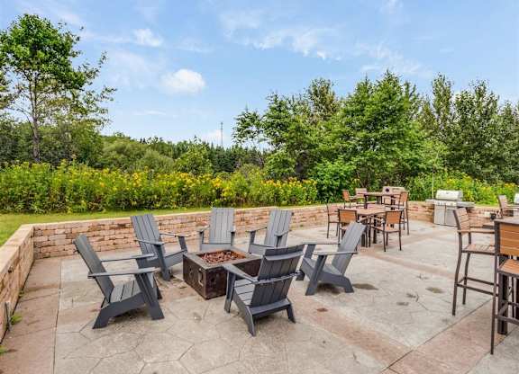 a patio with chairs and tables and a fire pit  at Campus Park, Duluth