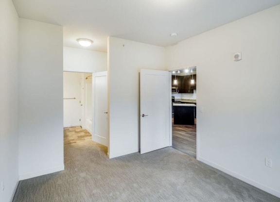 a hallway with white walls and a bathroom at Arbor Ridge, Forest Lake, Minnesota