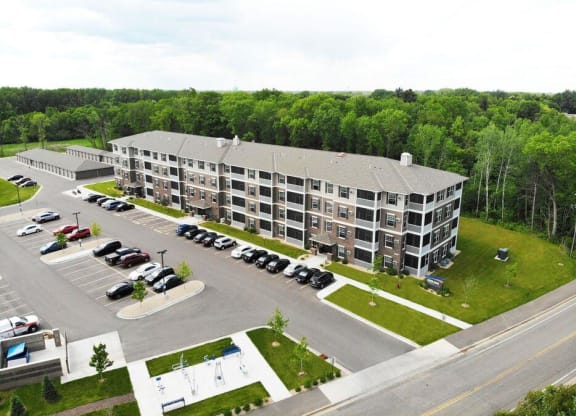 an aerial view of a large apartment building in a parking lot at Arbor Ridge, Forest Lake, MN, 55025