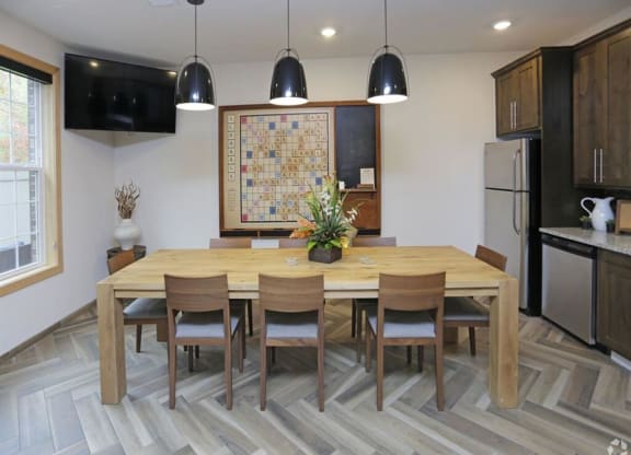 a dining room with a wooden table and chairs at Arbor Ridge, Forest Lake, MN