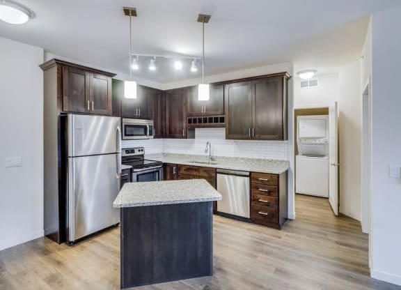 a kitchen with stainless steel appliances and a marble counter top at Arbor Ridge, Forest Lake, 55025