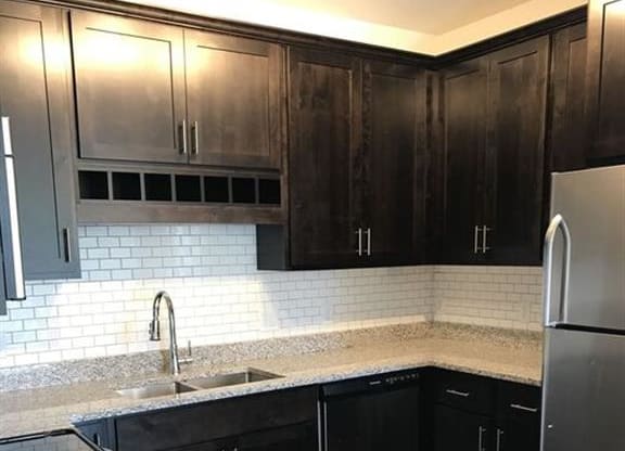 a kitchen with black cabinets and a stainless steel refrigerator at Arbor Ridge, Forest Lake