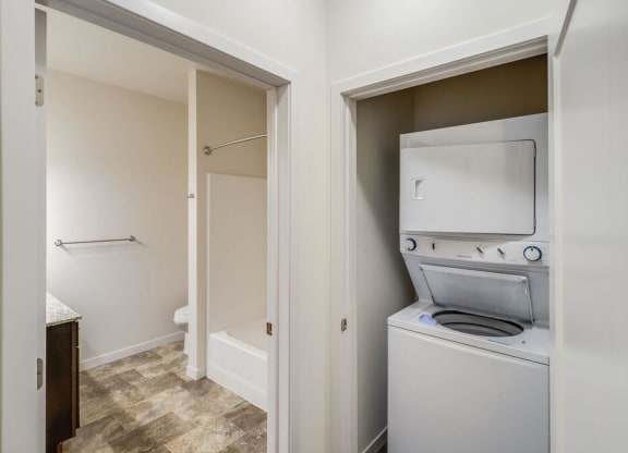 a washer and dryer in a laundry room with a door to a bathroom at Arbor Ridge, Forest Lake, 55025