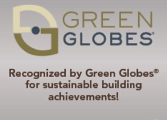 the logo of green globes is displayed on a white wall at Arbor Ridge, Forest Lake, Minnesota