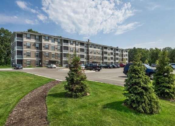 an apartment building on the corner of a parking lot at Arbor Ridge, Forest Lake, 55025