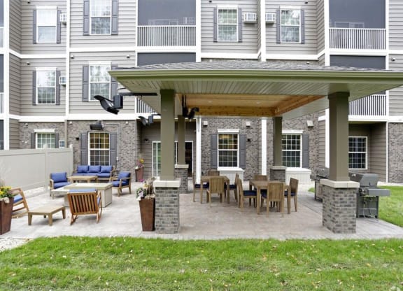 a covered patio with a table and chairs at Arbor Ridge, Forest Lake, Minnesota