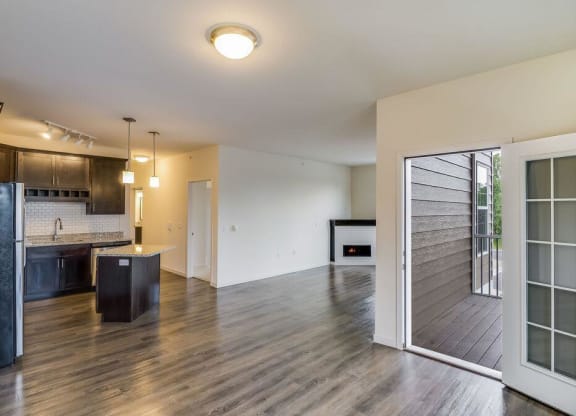 a living room and kitchen with a sliding glass door at Arbor Ridge, Forest Lake, Minnesota