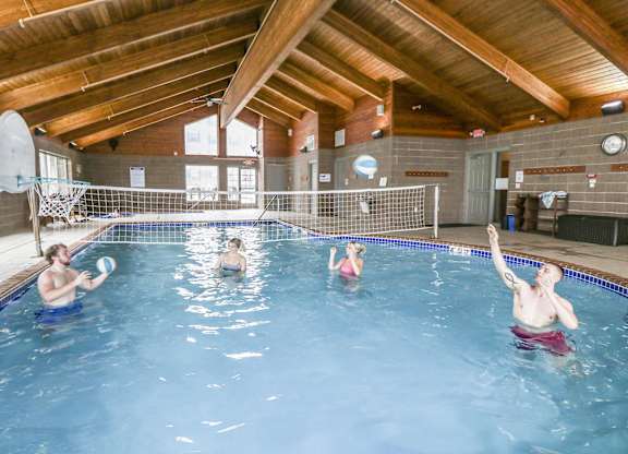 a group of people in a swimming pool playing with a frisbee at Campus Park, Duluth, 55811