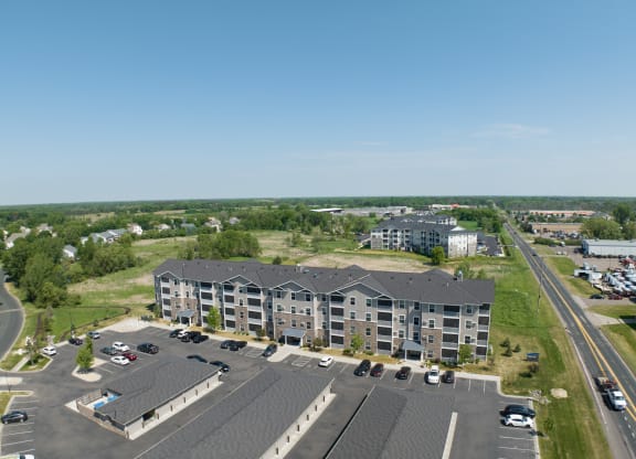 an aerial view of a city street with buildings and trees  at Timber Ridge, Minnesota, 55025