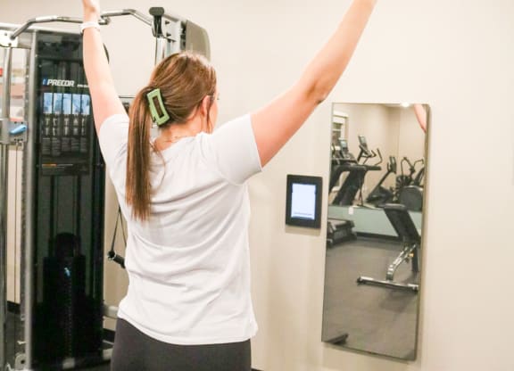 a woman standing in a gym with her arms in the air  at Timber Ridge, Forest Lake, MN, 55025