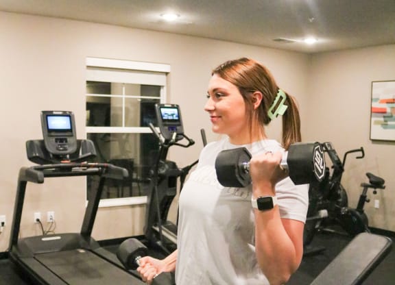 a woman doing a dumbbell workout in a gym  at Timber Ridge, Forest Lake, MN