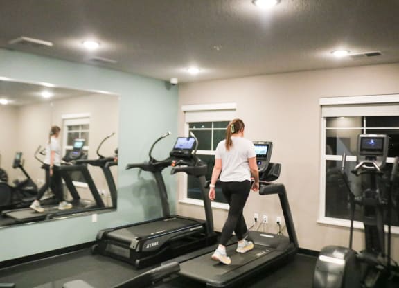 a woman running on a treadmill in a gym  at Timber Ridge, Forest Lake, MN, 55025