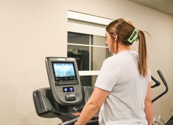 a woman running on a treadmill at the gym  at Timber Ridge, Minnesota