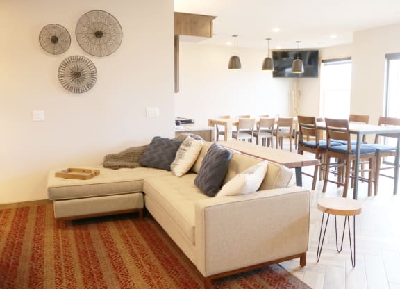 a living room with a couch and a dining room table  at Timber Ridge, Forest Lake, 55025