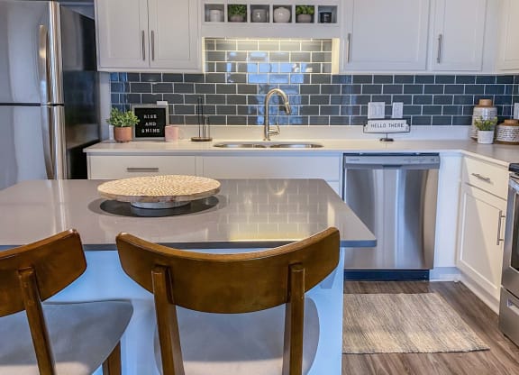 a kitchen with a center island and three stools  at Timber Ridge, Forest Lake