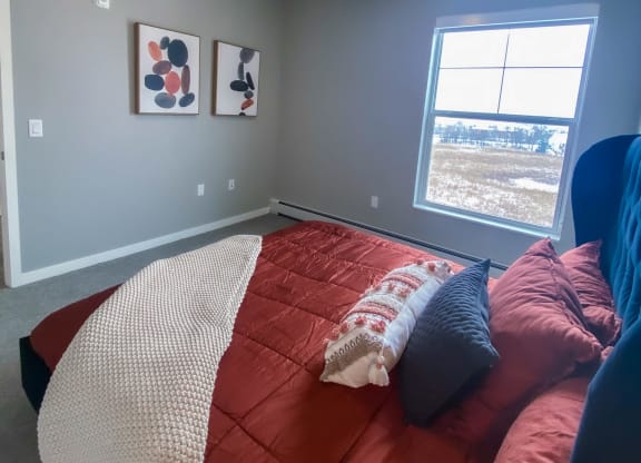 a bedroom with a bed and a window  at Timber Ridge, Forest Lake, MN