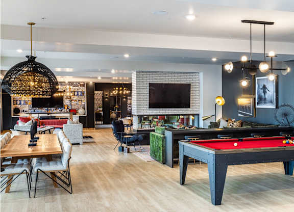 pool in a room with a pool table.at Converge KC Uptown, Kansas City, 64111