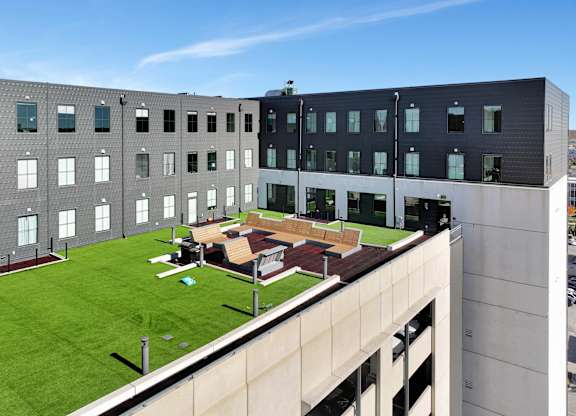 the rooftop of a building with a patio and lawn at Parkhaus Apartments,Nebraska