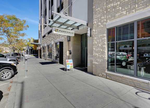 a street view of a building with a parking meter on the sidewalk at Parkhaus Apartments, Lincoln, Nebraska