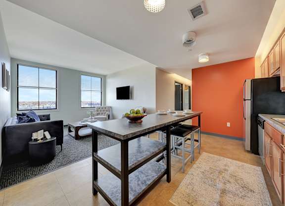 an open kitchen and living room with a dining room table at Parkhaus Apartments,Nebraska