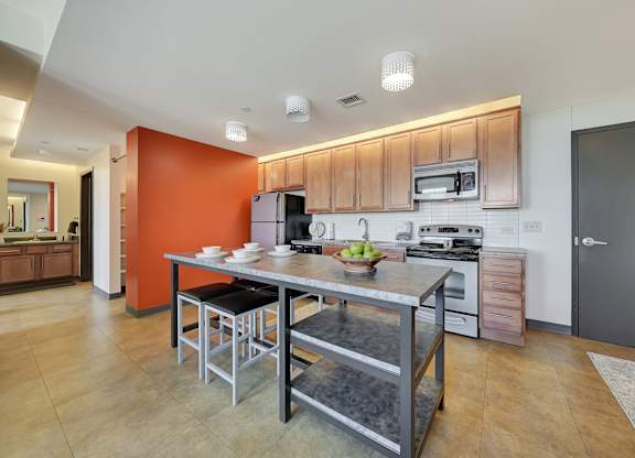 a kitchen with a center island and stainless steel appliances at Parkhaus Apartments, Lincoln