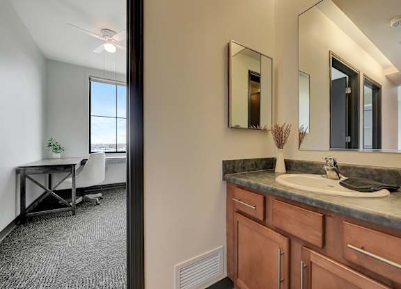 the view of a bathroom with a sink and a mirror from the doorway at Parkhaus Apartments,Nebraska 68508