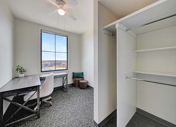 an office with a desk and a window and a closet at Parkhaus Apartments, Lincoln, 68508
